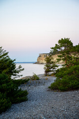 Stone beach with chalk cliff background