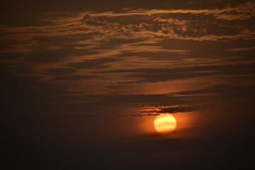 Vintage image of sunset sky with dark dramatic clouds.