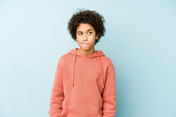 African american little boy isolated confused, feels doubtful and unsure. - obrazy, fototapety, plakaty