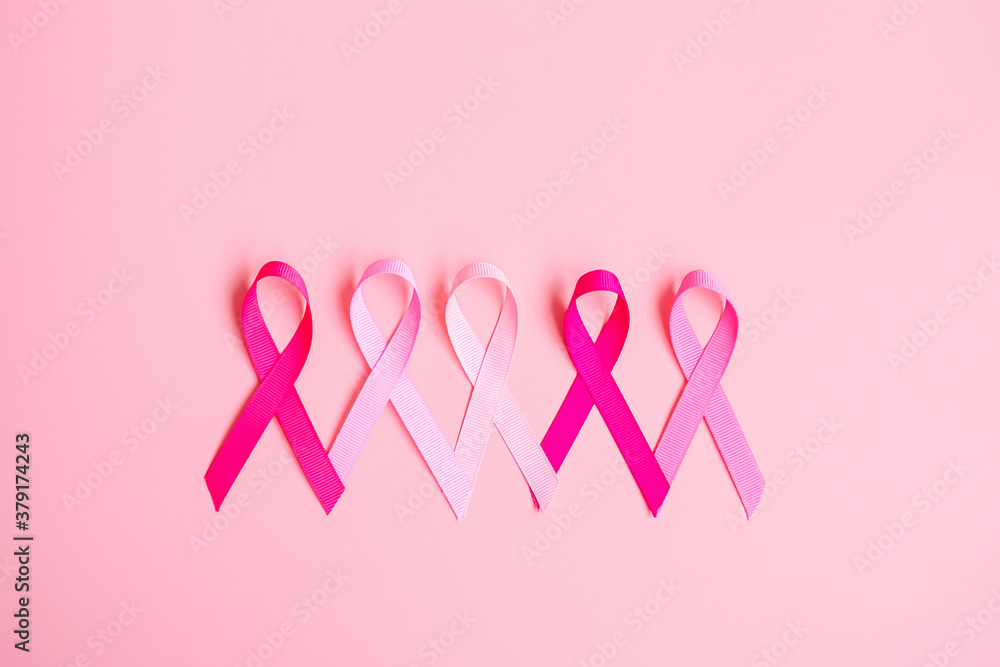 Wall mural october breast cancer awareness month, pink ribbon on pink background for supporting people living a