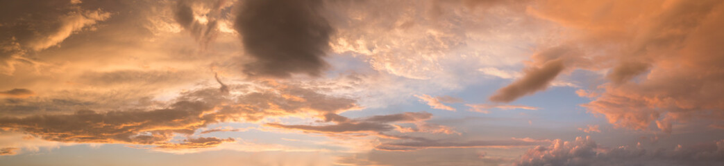 Naklejka na ściany i meble wide sunset sky panorama with yellow gray and orange clouds