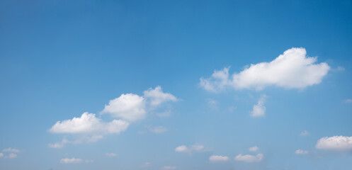 Naklejka na ściany i meble blue sky with some soft cumulus clouds, copy space above