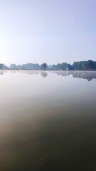 Fishing lake in the foggy morning