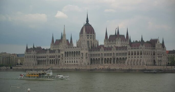 Boat sailing in Danube river in front of Budapest Parliament