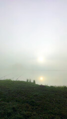 Fishing lake in the foggy morning