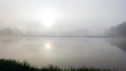 Fototapeta na wymiar Fishing lake in the foggy morning