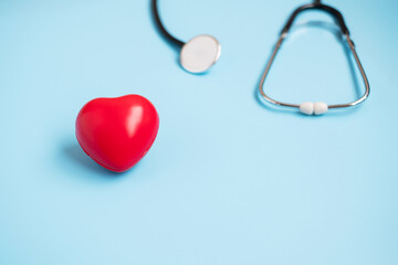 Top view Stethoscope with Red heart shape on blue background with copy space for text. Healthcare, life Insurance, Health day, World Heart Day and Happy Doctor day concept