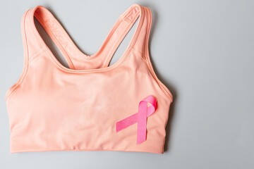 Breast Cancer Awareness month, Pink Ribbon on female sport bar on grey background for supporting...