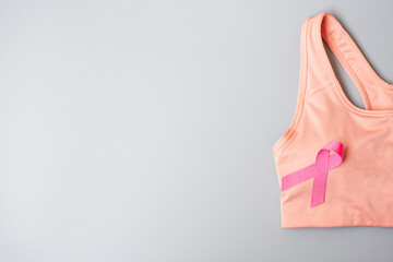 Breast Cancer Awareness month, Pink Ribbon on female sport bar on grey background for supporting people living and illness. Healthcare, International Women day and World cancer day concept