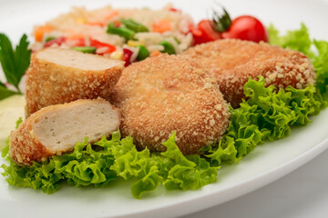 Chicken cutlets in batter with risotto and vegetables