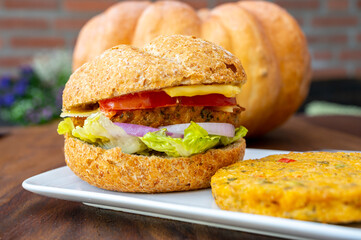 Making fresh and healthy vegetarian hamburgers with grilled pumpkin burgers, organic buns and vegetables