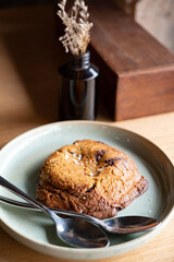 Food series: Big brown cookie with two spoons on wooden table