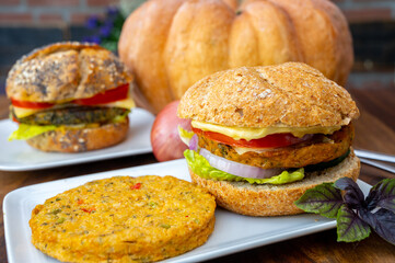 Making fresh and healthy vegetarian hamburgers with grilled pumpkin burgers, organic buns and vegetables