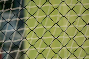 Fototapeta premium Football or Soccer net blend together with Metal fence net close up . Texture . Pattern. Background.