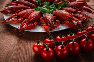 Crayfish on a plate with cherry tomatoes chili peppers and herbs