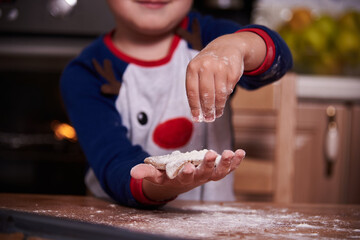 Baby's hands close up with homemade cookies