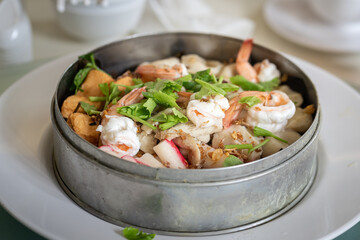 Mixed steam seafood "Shrimp, fish and crab stick" that served on the table in premium buffer restaurant.  Selective focus on the center part.