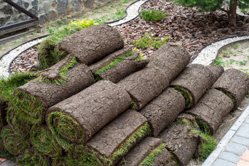 stacks of sod rolls for new lawn
