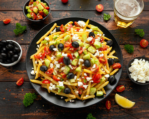 Loaded potato Vegan Fries with tomato, cucumber, olives and feta cheese