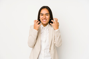 Young woman isolated on a white background upset screaming with tense hands.