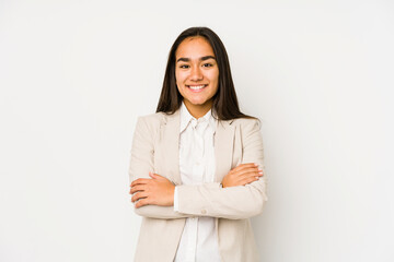 Young woman isolated on a white background who feels confident, crossing arms with determination.