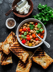 Ingredients for  goats cheese crostini with garlicky beans on a dark background, tp view