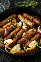 Rosemary and onion vegetarian vegan sausages oven baked in cast iron skillet frying pan