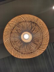 Round decorative light. From woven rattan