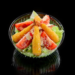 Shrimp tempura and salad of fresh vegetables close-up