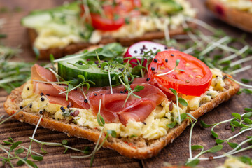 Sandwiches with cream cheese, vegetables and salami.