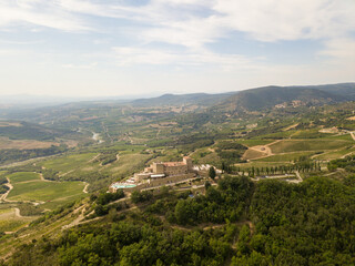 Fototapeta na wymiar Castle in the Tuscany /Toscana aerial/drone with vineyards and olive trees in the background