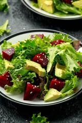 Vegetarian avocado and beet salad in plate. Healthy vegan food