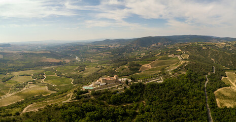 Fototapeta na wymiar Castle in the Tuscany /Toscana aerial/drone with vineyards and olive trees in the background