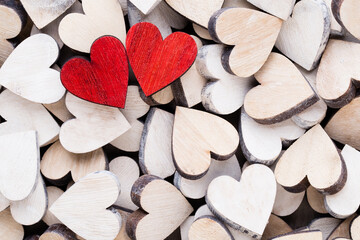 Valentines day background with white end red hearts on wooden background.