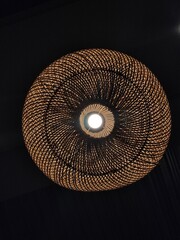 Round decorative light. From woven rattan	
