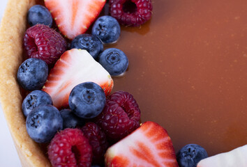 strawberry cheesecake and fresh berries on a white table