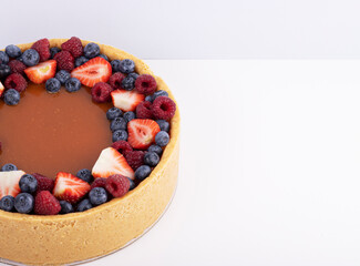 strawberry cheesecake and fresh berries on a white table