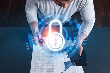 Obraz premium Handsome man working on Data protection project. Multiexposure. Lock icon hologram.