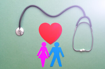 Family paper cut out with red heart and stethoscope, heart health, family health insurance concept.