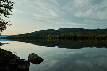 Dead still water at Krøderen. Norway's second largest lake. Calm weather in autumn. Shot in september.