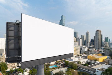 Fototapeta premium Blank white road billboard with Bangkok cityscape background at day time. Street advertising poster, mock up, 3D rendering. Side view. The concept of marketing communication to promote or sell idea.