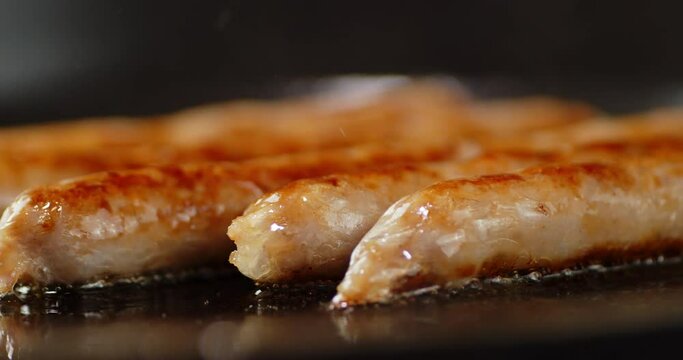 Fragrant fried sausage in a frying pan. 