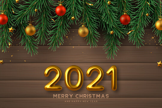 2021 New Year sign. Merry Christmas banner with realistic golden 3d numbers, gold and red balls, pine branches and stars. Wooden background. Vector illustration.