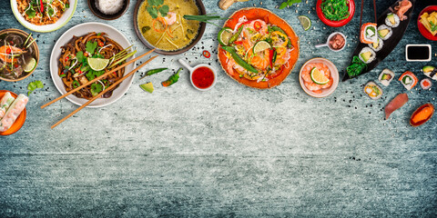Obraz na płótnie Canvas Asian food background with various ingredients on rustic stone background , top view. Vietnam or Thai cuisine.