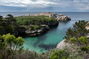 China Cove, as viewed from the hiking trails on cliffs above, at Point Lobos State Natural Reserve, a popular tourist destination in Carmel by the Sea, along the central pacific coast of California. 