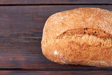 Fresh bakery on the wooden table. Сrispy flavored bread on the wooden board.