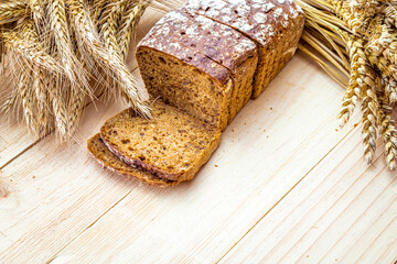 Freshly baked bread. Fresh loaf of rustic traditional bread with wheat grain ear or spike plant on...