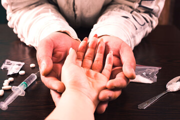 Hands helping drug addict teenage with syringe and ampoules. - obrazy, fototapety, plakaty