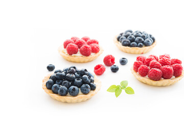 Mini tarts with berries isolated on a white background