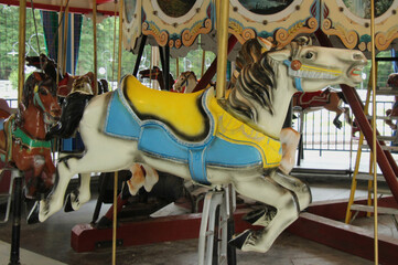 Fototapeta na wymiar White Carousel Horse with Yellow Saddle